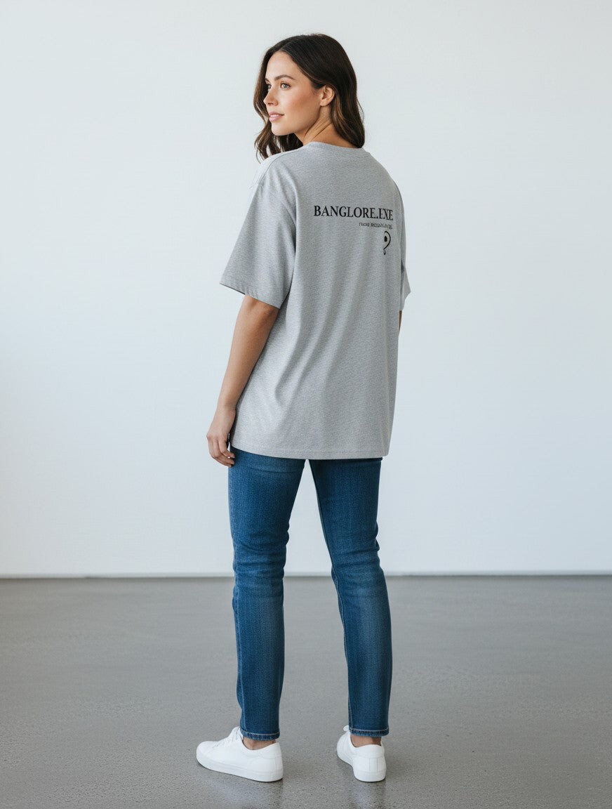 mi-DONE Bengaluru oversized grey cotton t-shirt with drop shoulders and black text print, worn by a woman with jeans.