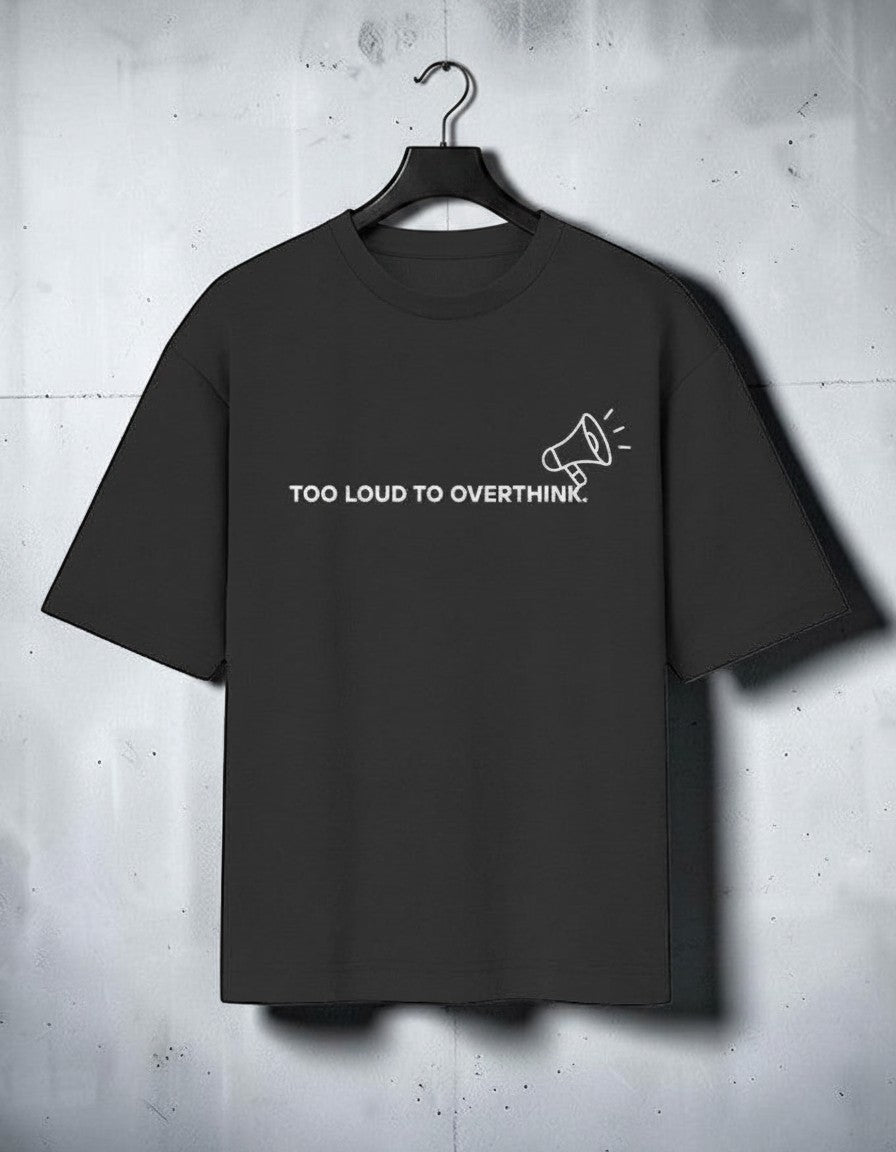 mi-DONE black oversized cotton t-shirt with Too Loud To Overthink text and megaphone graphic on a hanger