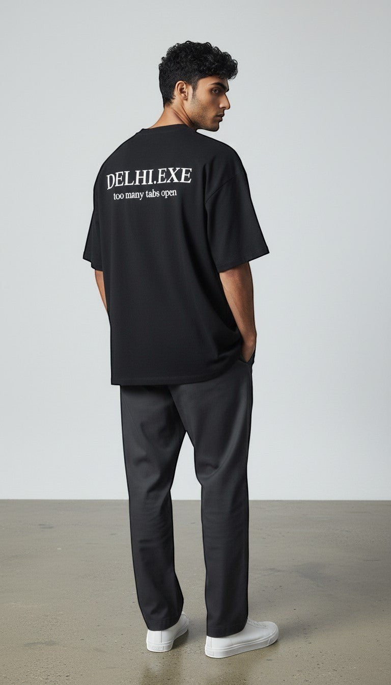 mi-DONE black oversized cotton t-shirt with Delhi.exe too many tabs open graphic print on back worn by a man