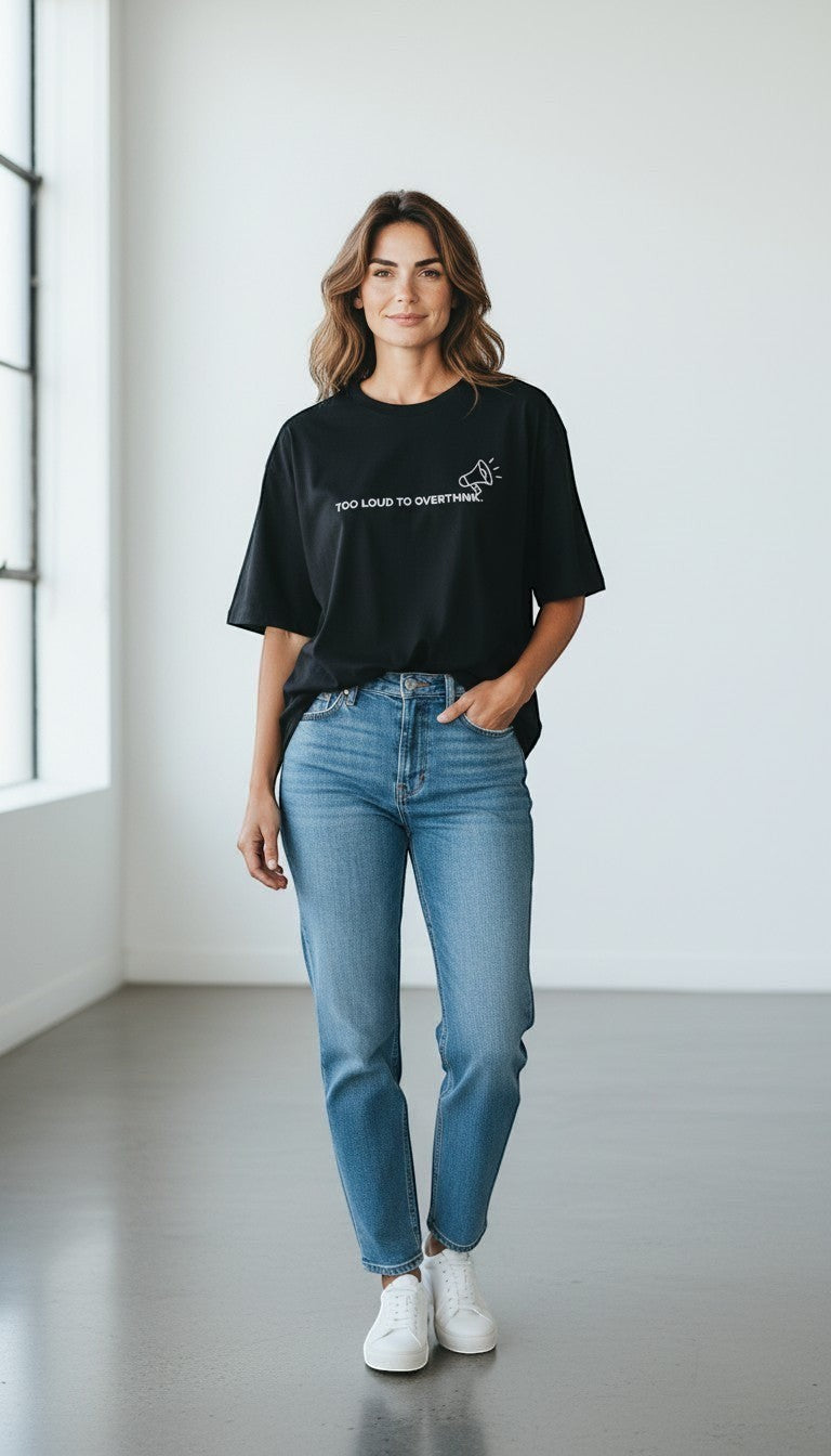 mi-DONE black oversized cotton t-shirt with Too Loud To Overthink graphic worn by a woman with blue jeans and sneakers