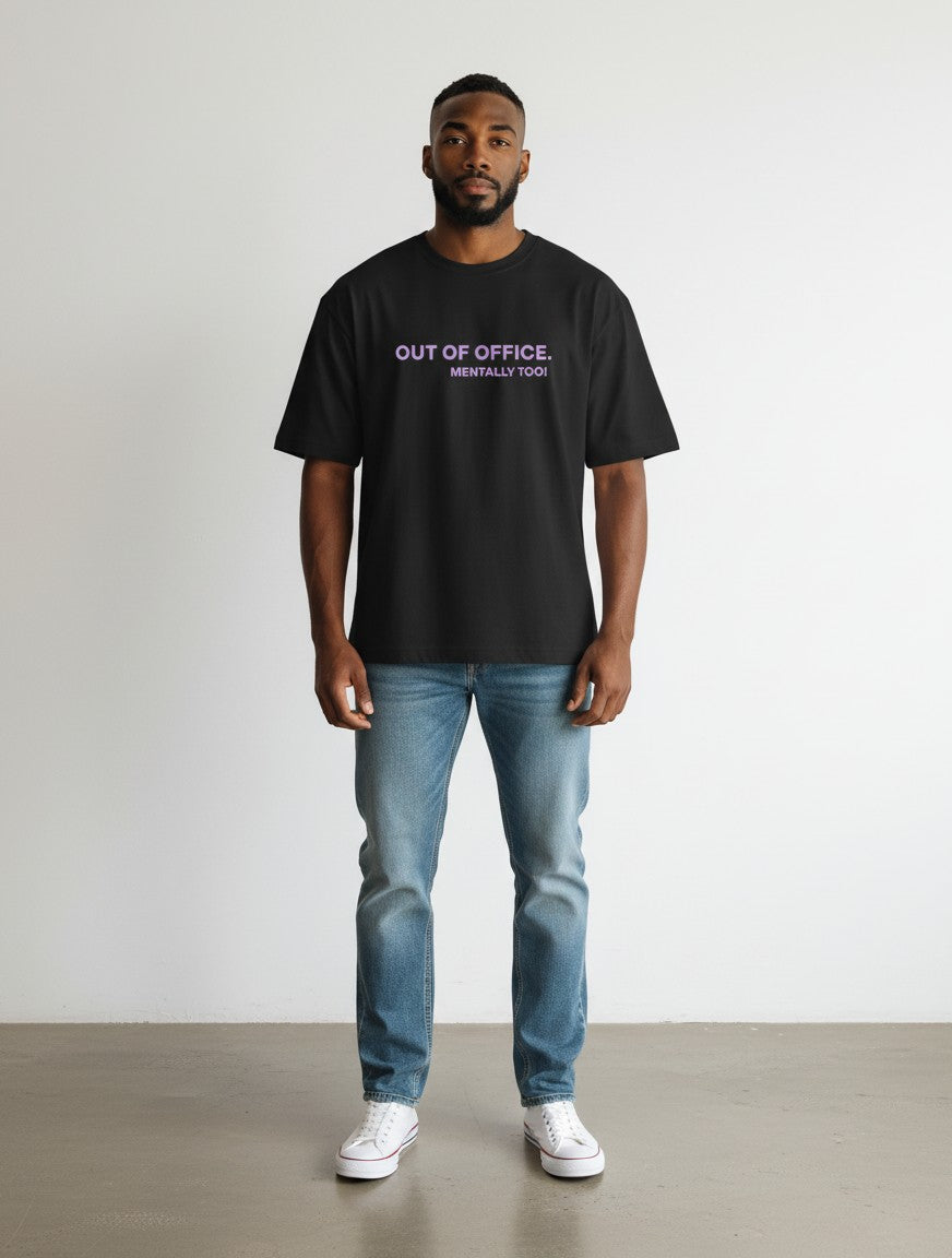 mi-DONE black oversized cotton t-shirt with Out Of Office graphic print worn by a man with blue jeans