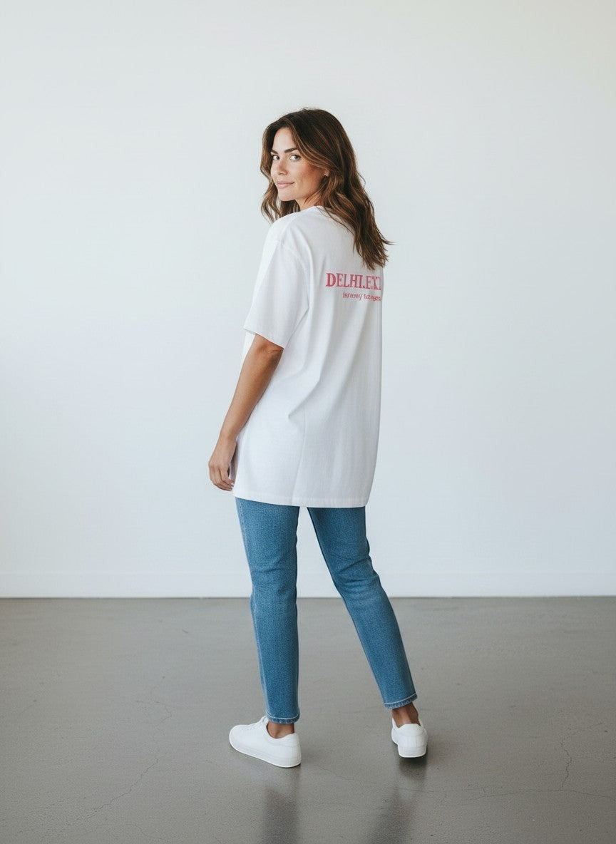 mi-DONE Delhi oversized white cotton t-shirt with pink back graphic worn by a woman with blue jeans and white sneakers