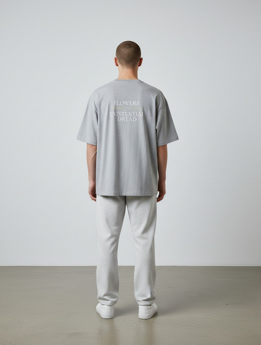 mi-DONE grey oversized cotton t-shirt with Flowers & Existential Dread back print worn by a man in grey joggers