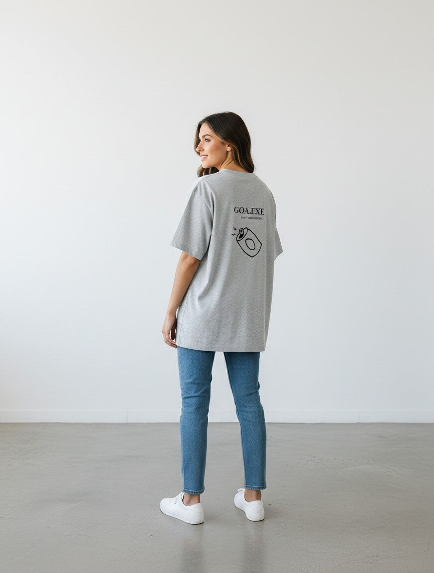 Woman wearing a grey mi-DONE oversized cotton t-shirt with a Goa graphic print on the back, paired with blue jeans.