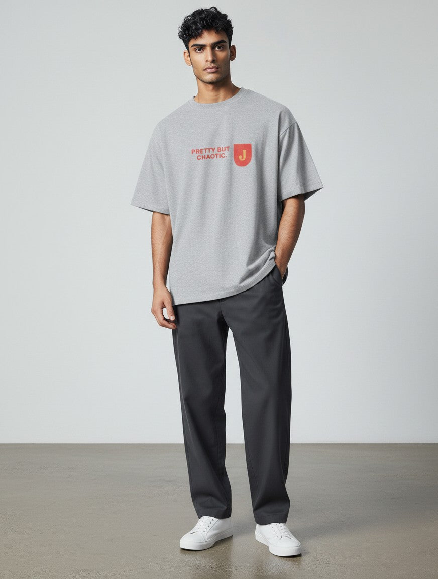 mi-DONE grey oversized cotton t-shirt with Pretty But Chaotic graphic print worn by a male model with dark trousers