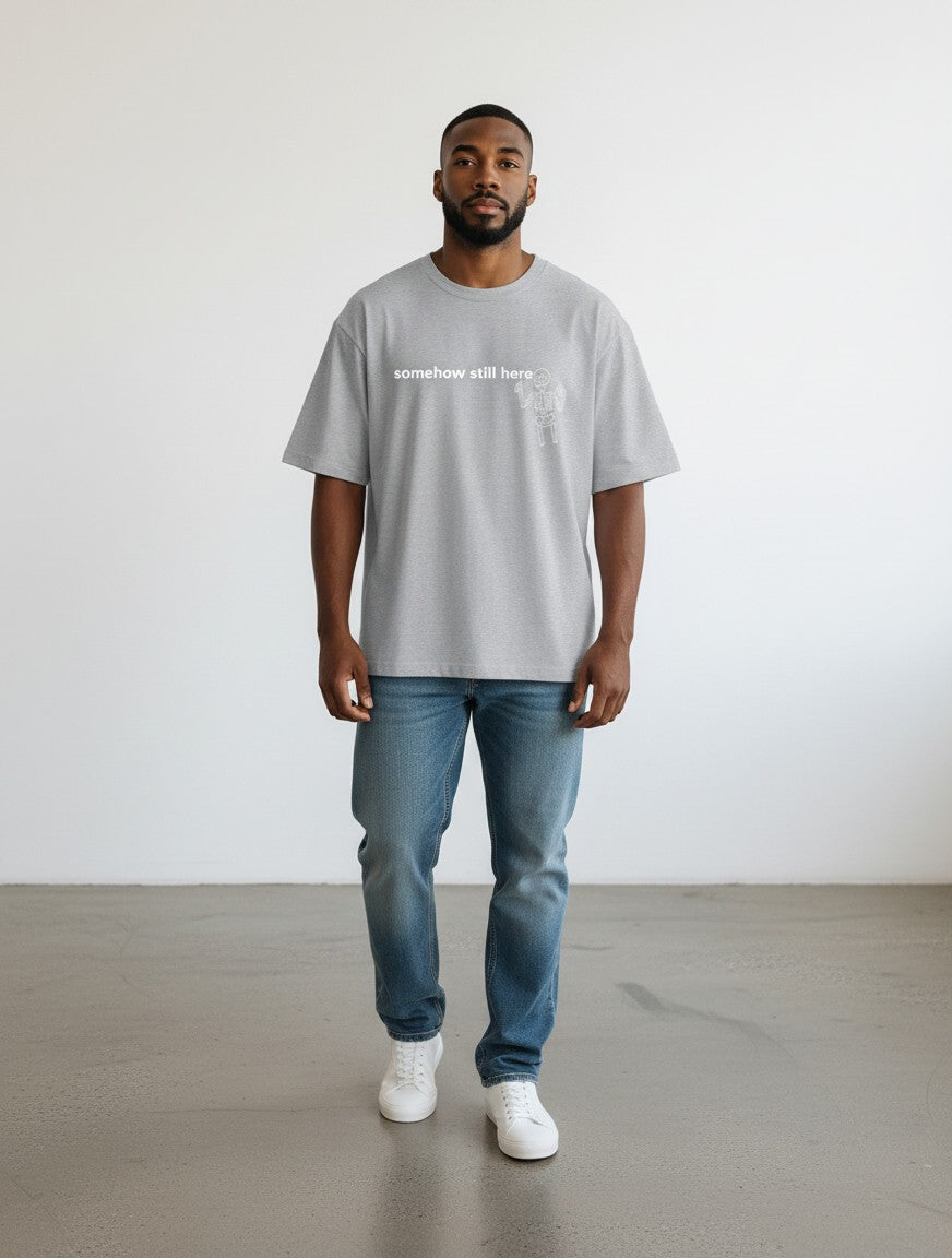 mi-DONE grey oversized cotton t-shirt with drop shoulders and graphic print worn by a man with blue jeans