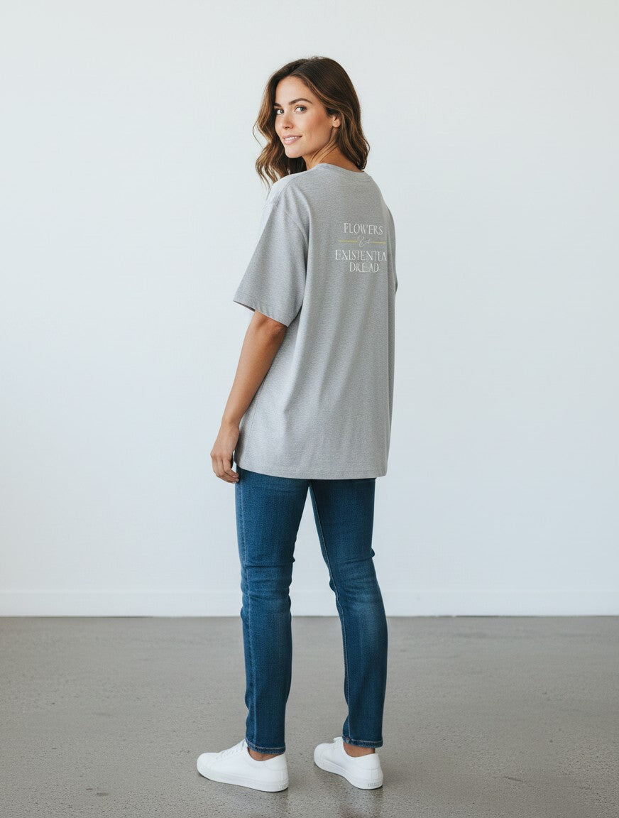 mi-DONE grey oversized cotton t-shirt with Flowers & Existential Dread back print worn by a woman with jeans