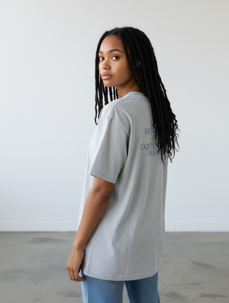 mi-DONE grey oversized cotton t-shirt with graphic print on back worn by a woman with braids