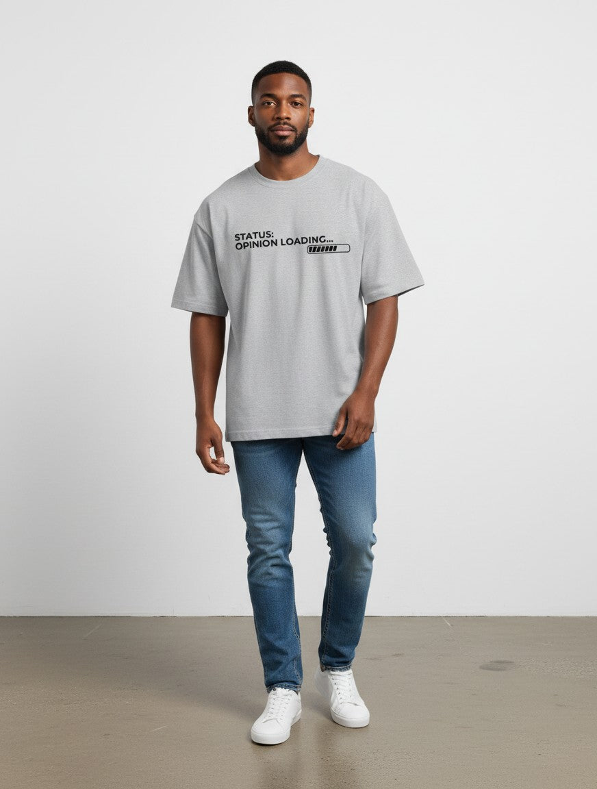 mi-DONE grey oversized cotton t-shirt with Opinion Loading graphic print worn by a man with blue jeans and sneakers
