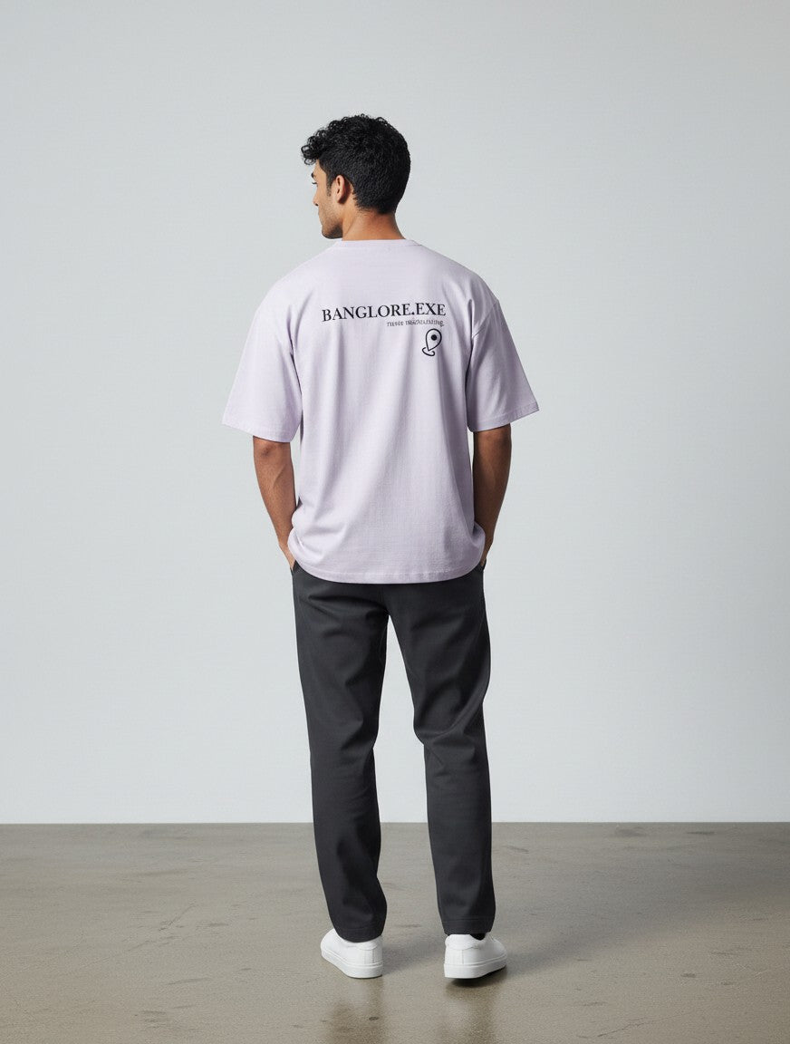 mi-DONE oversized lavender cotton t-shirt with Bengaluru graphic print on back, worn by a man with dark trousers