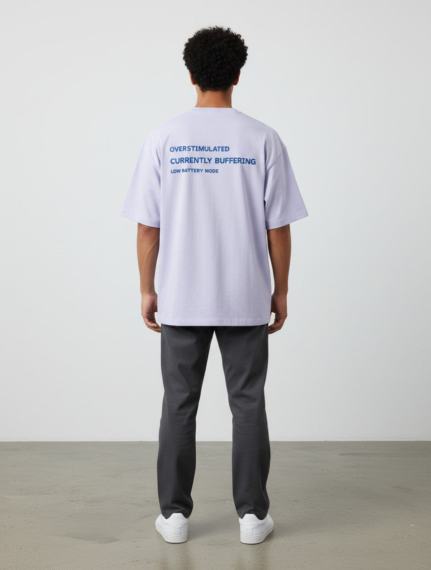 mi-DONE oversized lavender cotton t-shirt with blue text print on back, worn by a man with dark curly hair