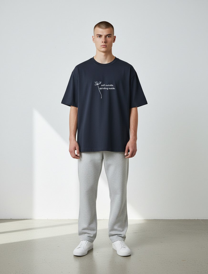 mi-DONE oversized navy blue cotton t-shirt with graphic print on a male model wearing grey joggers and white sneakers