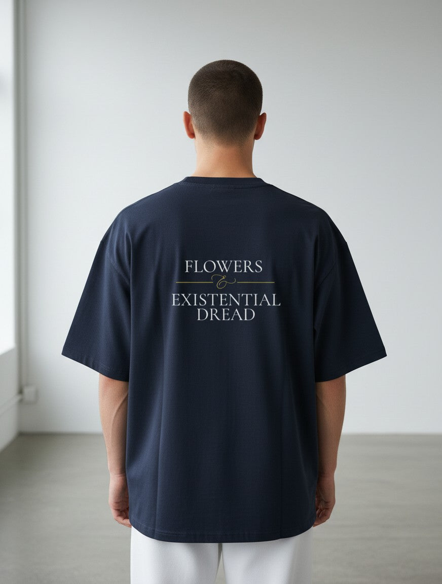 Back view of a man wearing a navy blue mi-DONE oversized cotton t-shirt with Flowers & Existential Dread text print