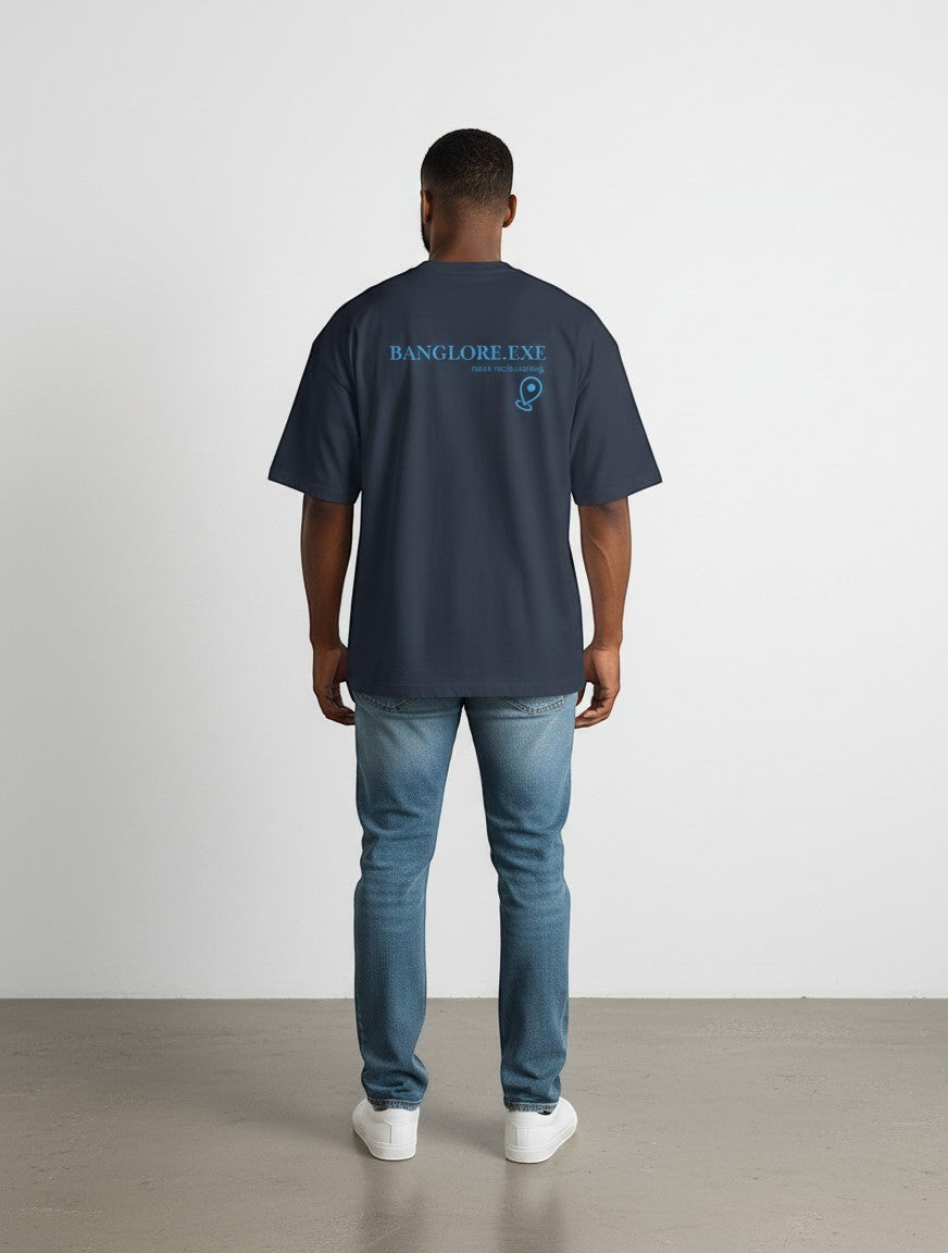 mi-DONE oversized navy blue cotton t-shirt with Currently Buffering graphic on the back, worn by a man with jeans.
