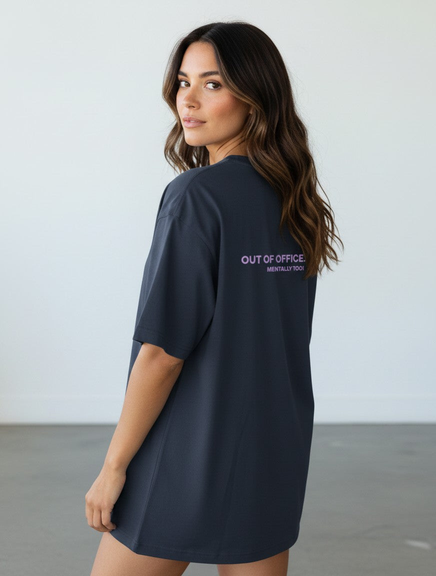 mi-DONE oversized charcoal grey cotton t-shirt with Out Of Office print on the back worn by a woman