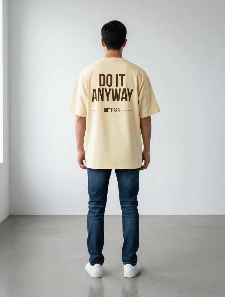 mi-DONE oversized cream cotton t-shirt with brown Do It Anyway But Tired graphic print on back, worn by a man