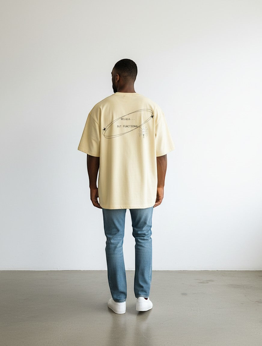 mi-DONE oversized cream cotton t-shirt with Delulu But Functional graphic on back, worn by a man with blue jeans.