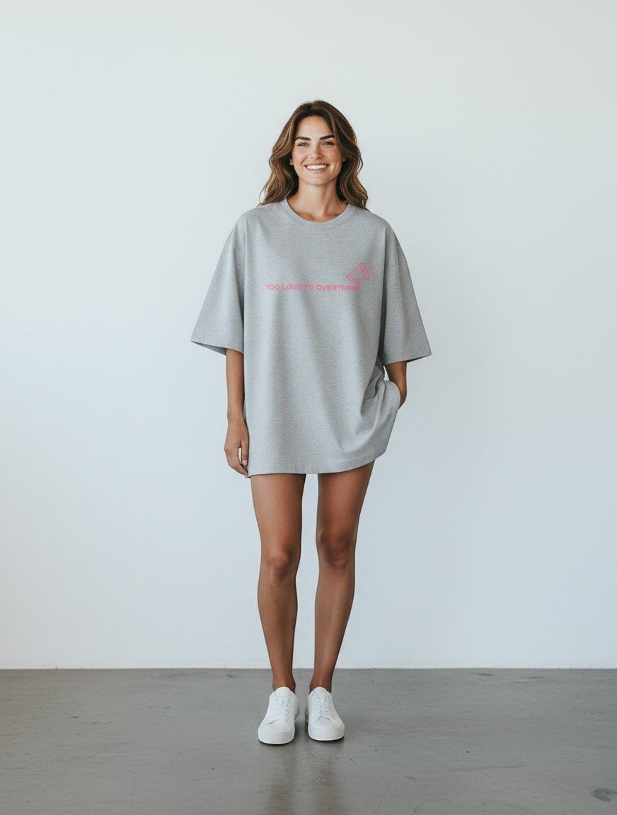 mi-DONE oversized grey cotton t-shirt with pink graphic print worn by a smiling woman with white sneakers