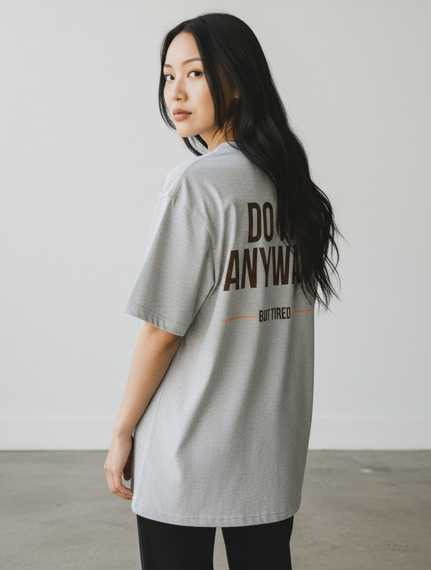 mi-DONE oversized grey cotton t-shirt with brown text print on the back worn by a woman