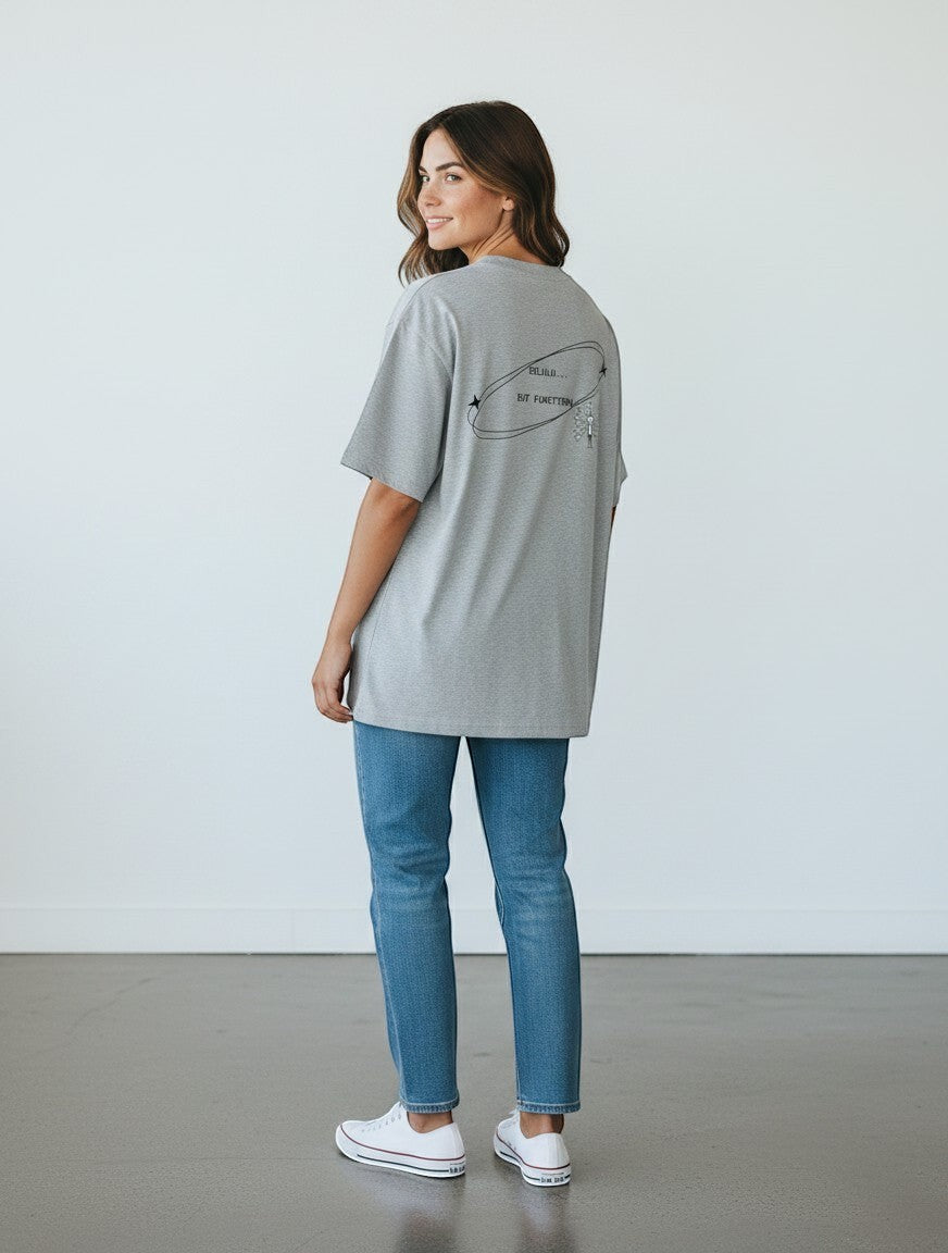 mi-DONE oversized grey cotton t-shirt with Delulu But Functional graphic on back, worn with blue jeans and sneakers