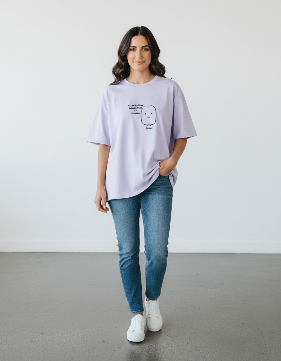 mi-DONE oversized lavender cotton t-shirt with graphic print worn by a woman with blue jeans and white sneakers