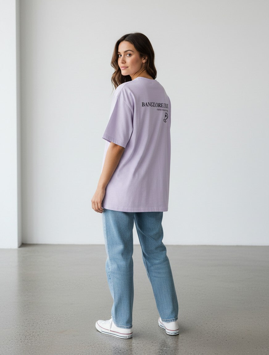mi-DONE oversized lavender cotton t-shirt with Bengaluru graphic print, worn by a woman with blue jeans