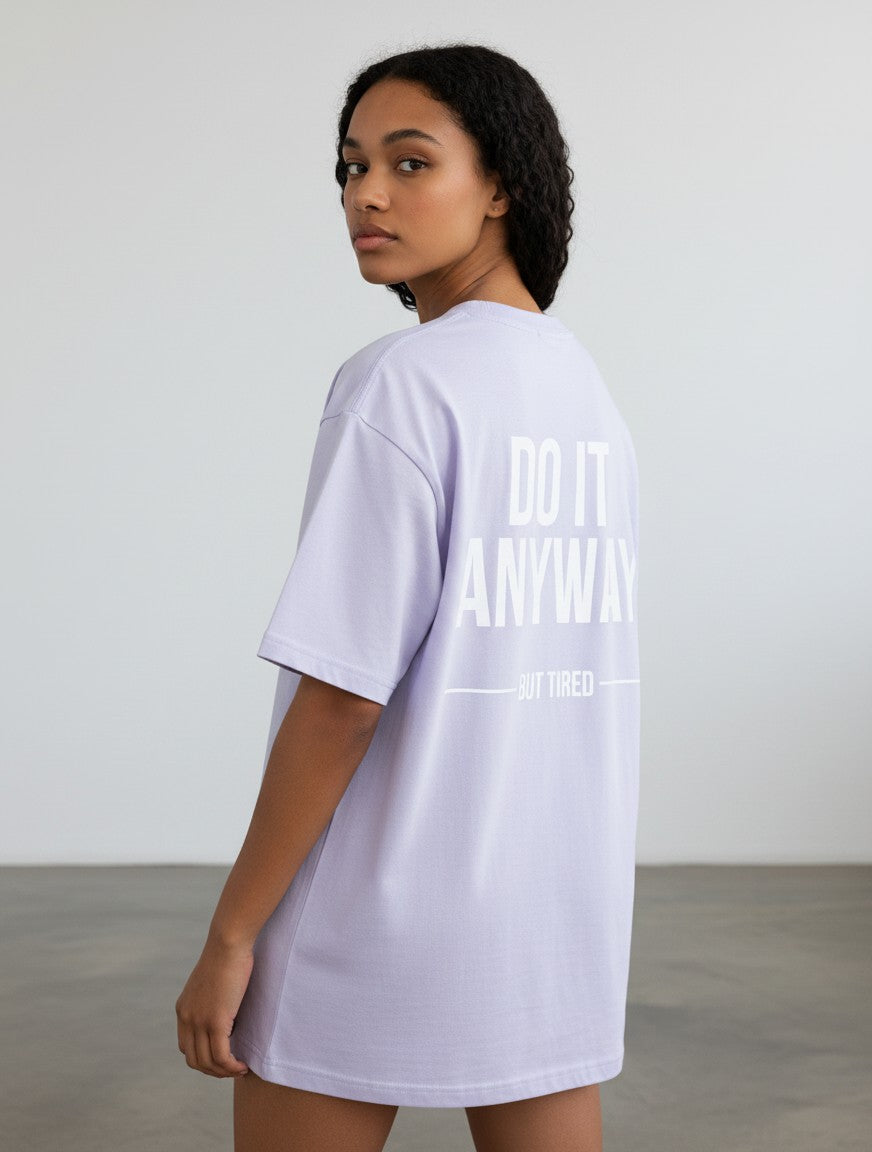 mi-DONE oversized lavender cotton t-shirt with Do It Anyway But Tired graphic print on the back worn by a woman