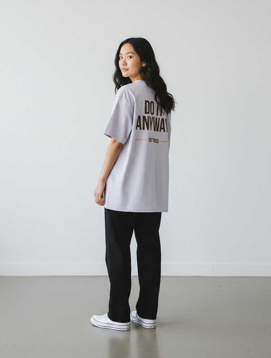 mi-DONE oversized lavender t-shirt with back graphic print worn by a woman with black pants and white sneakers