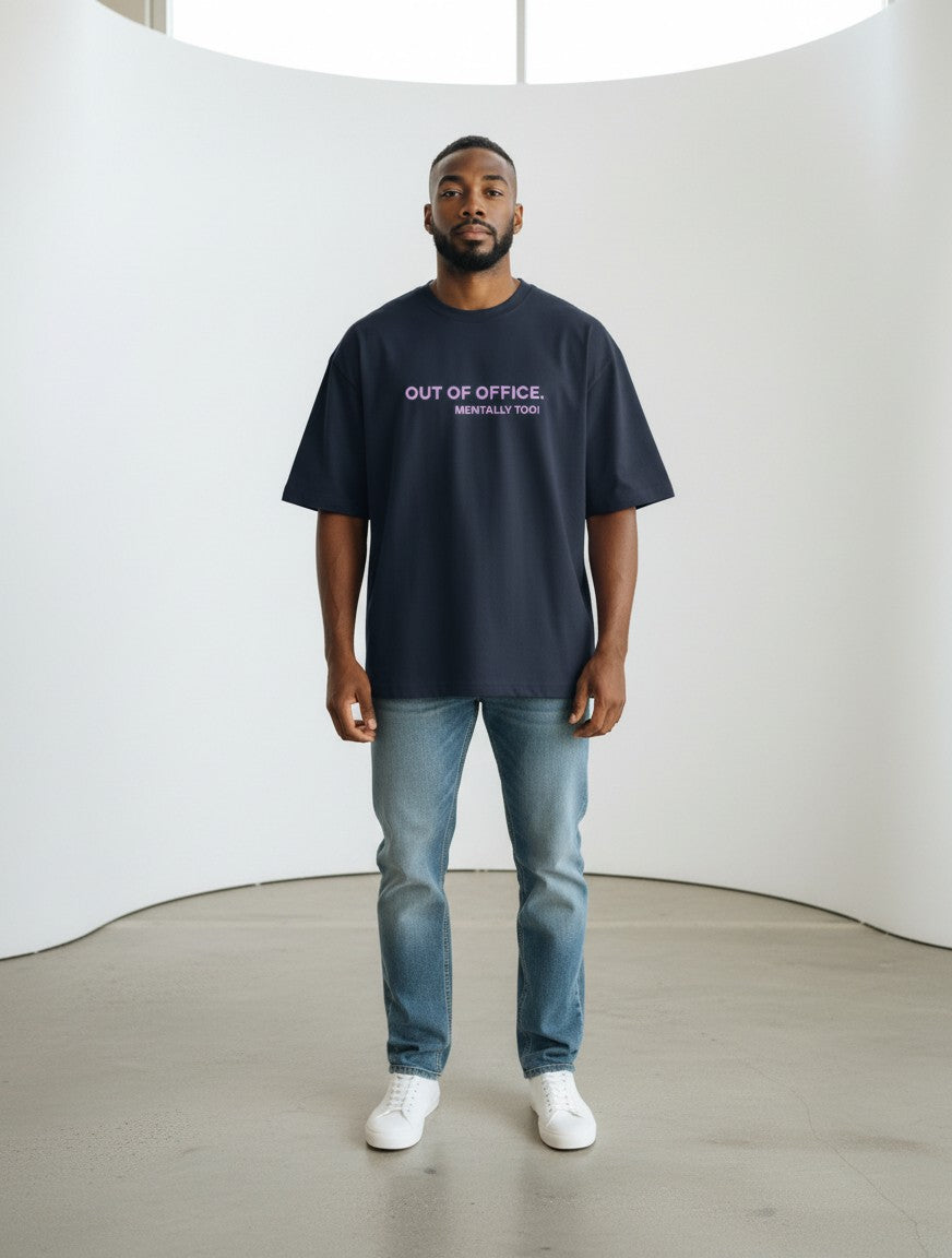 mi-DONE oversized navy blue cotton t-shirt with Out Of Office print worn by a man with blue jeans and white sneakers