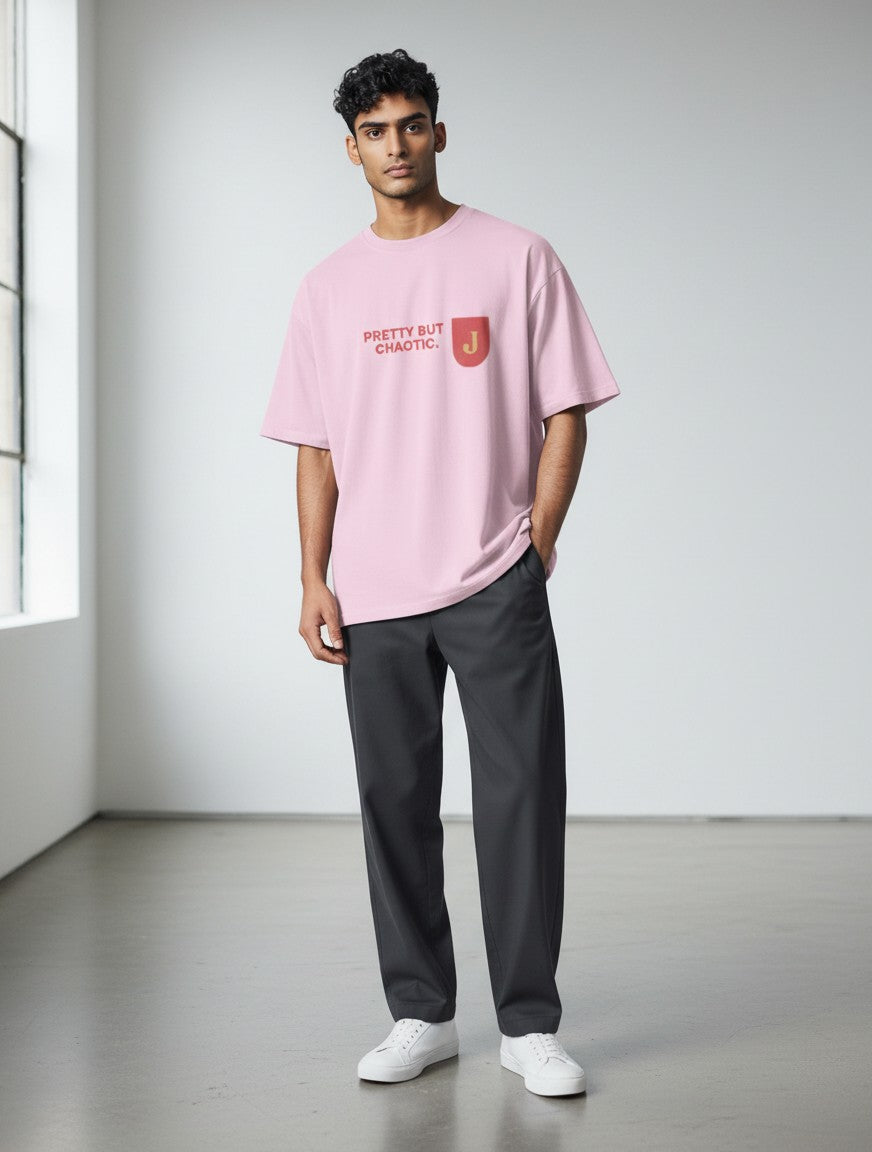 mi-DONE oversized pink cotton t-shirt with Pretty But Chaotic print worn by a man with dark grey trousers