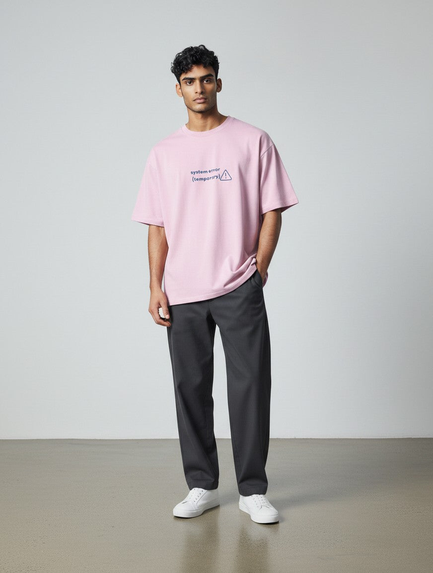 Model wearing a mi-DONE oversized pink cotton t-shirt with System Error graphic print and drop shoulders.