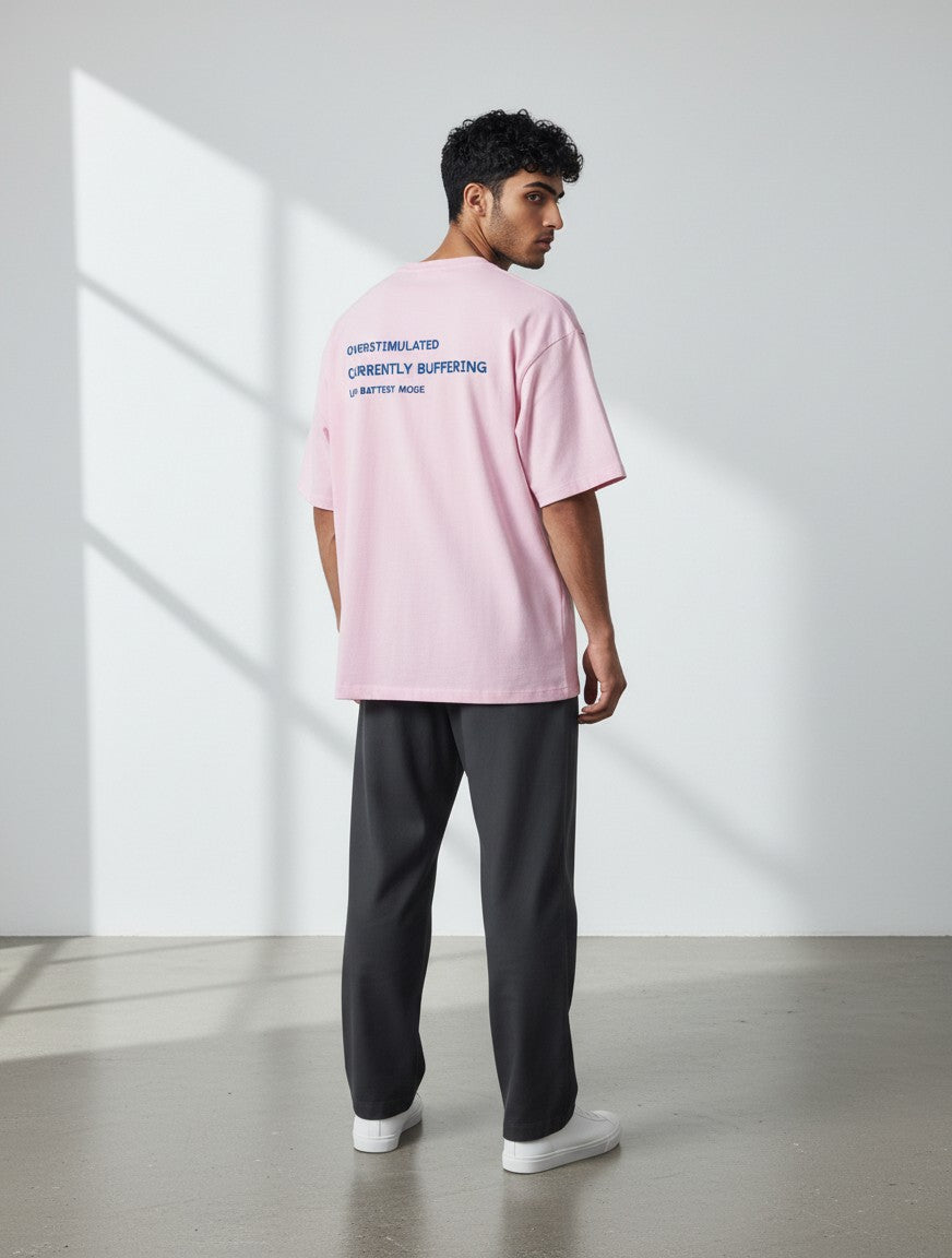 mi-DONE oversized pink cotton t-shirt with System Error graphic print on back, worn by a man with dark trousers.