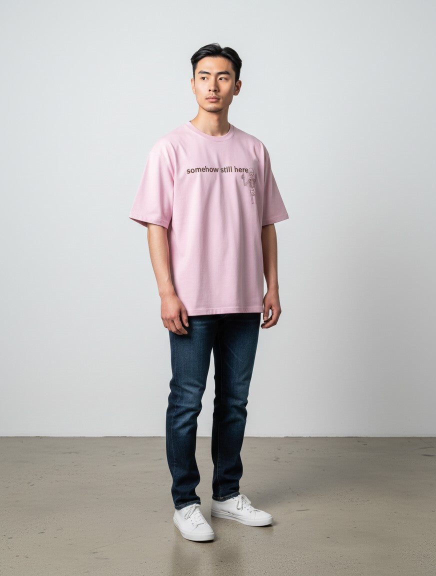 mi-DONE oversized pink cotton t-shirt with skeleton graphic print worn by a man with dark jeans and white sneakers