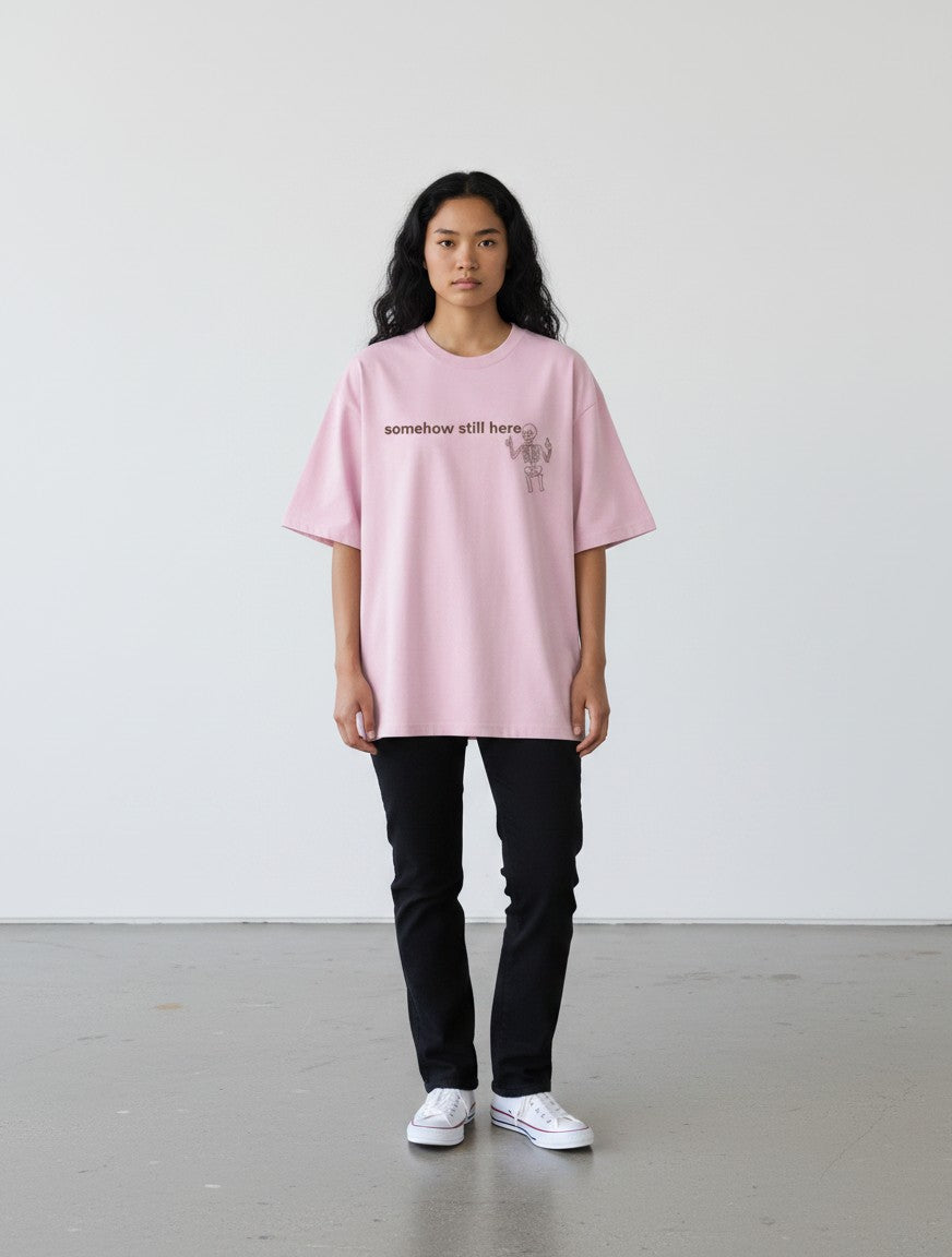 mi-DONE oversized pink cotton t-shirt with skeleton graphic and text print worn by a model with black jeans
