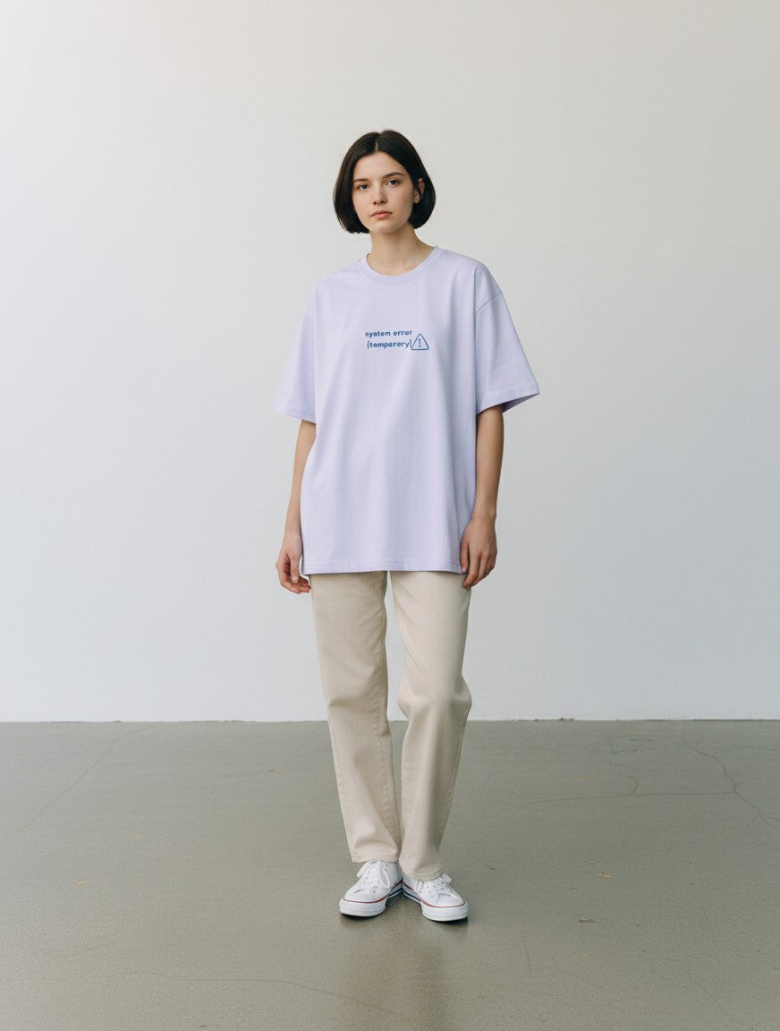 Model wearing a mi-DONE oversized light purple cotton t-shirt with System Error graphic print and drop shoulders