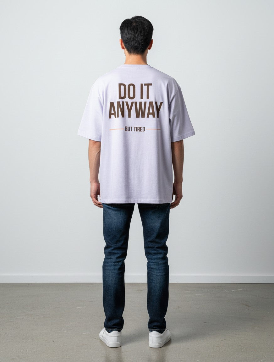 mi-DONE oversized light purple cotton t-shirt with Do It Anyway But Tired graphic print on the back worn by a man