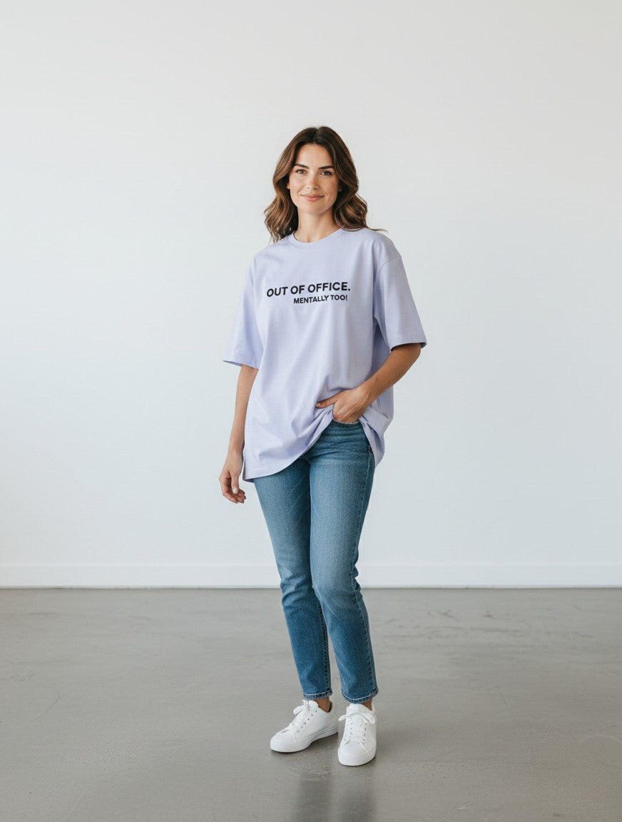 mi-DONE oversized light purple cotton t-shirt with Out of Office graphic print worn by a woman with blue jeans
