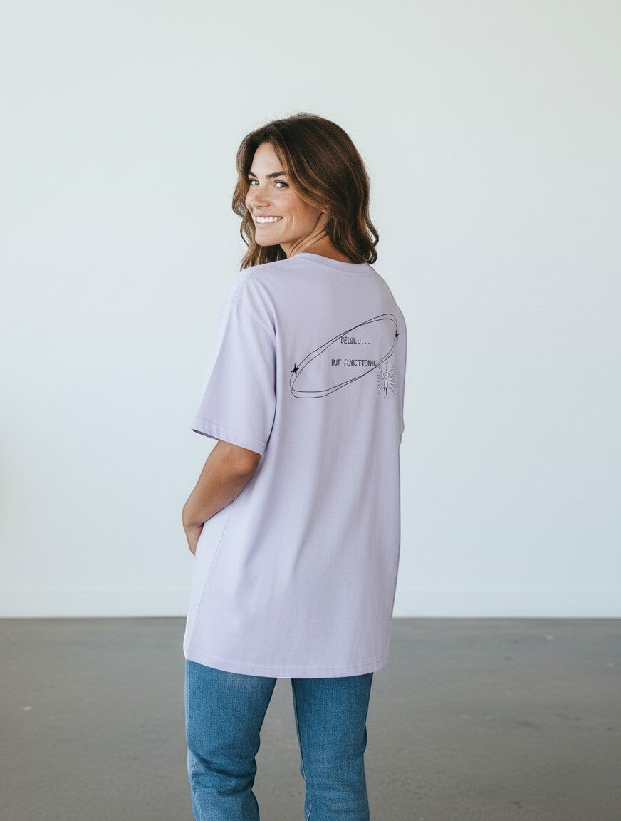 mi-DONE oversized light purple cotton t-shirt with Delulu But Functional graphic print on the back, worn by a woman