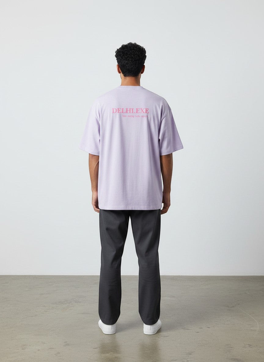 Back view of a man wearing a mi-DONE oversized light purple cotton t-shirt with Delhi.exe print and drop shoulders.