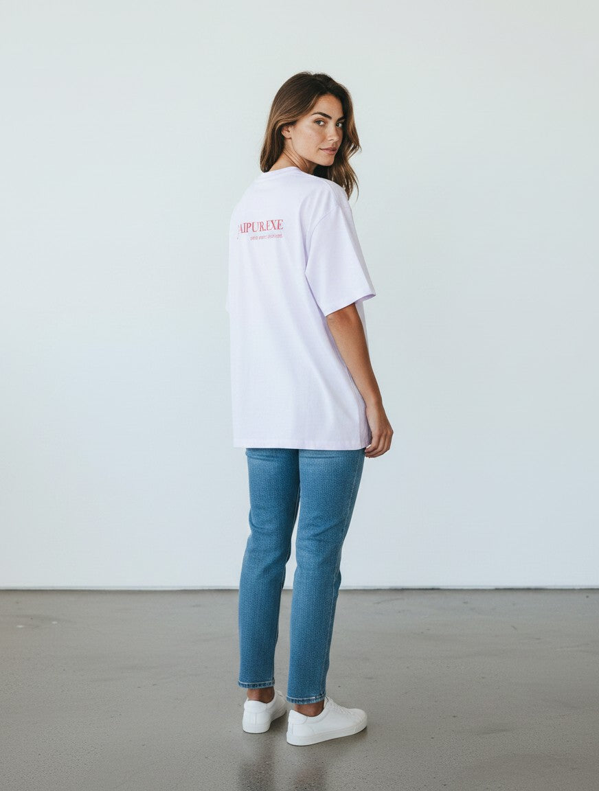 mi-DONE oversized white cotton t-shirt with drop shoulders and red back graphic, worn by a woman with blue jeans
