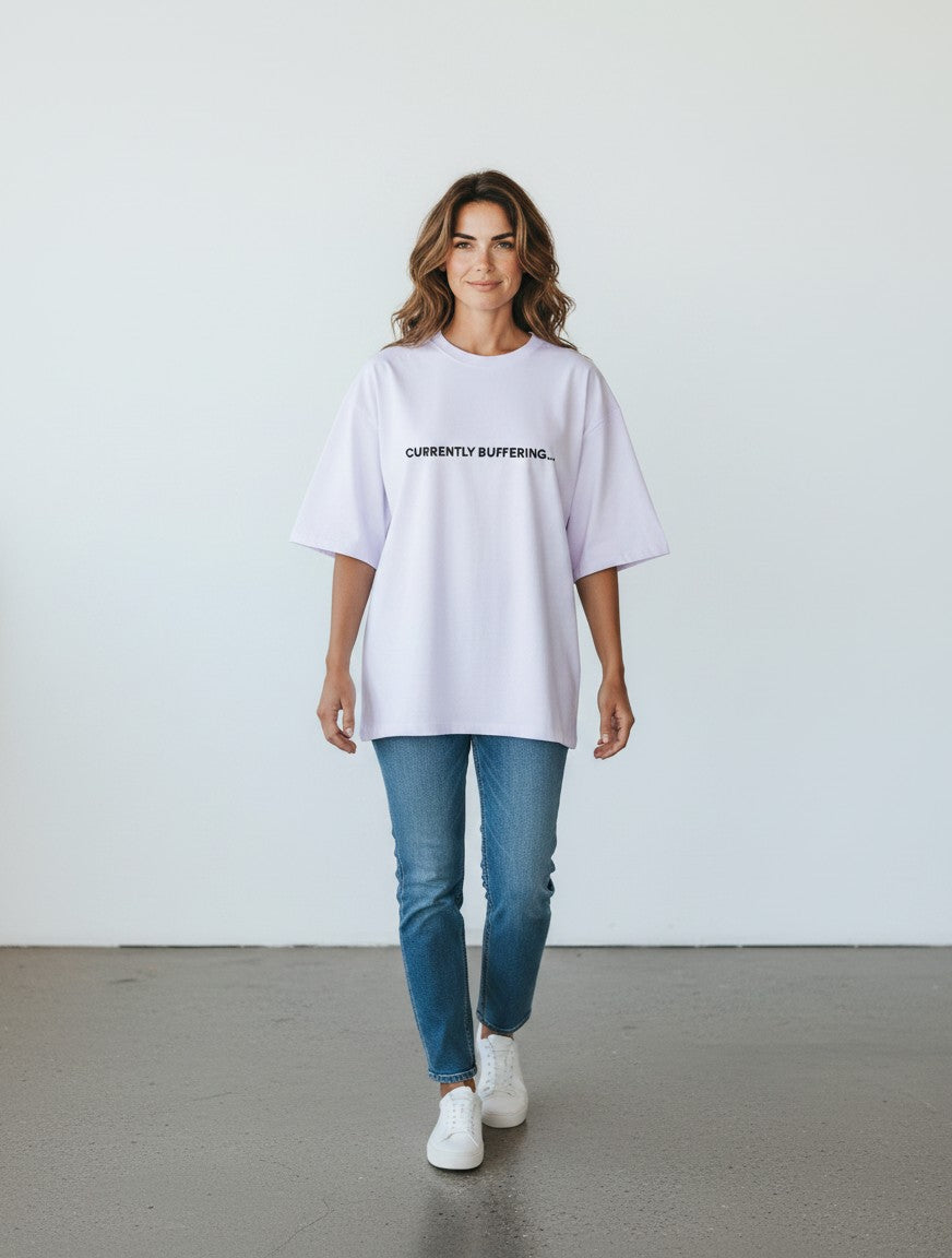 mi-DONE oversized white cotton t-shirt with Currently Buffering text print worn by a woman with blue jeans