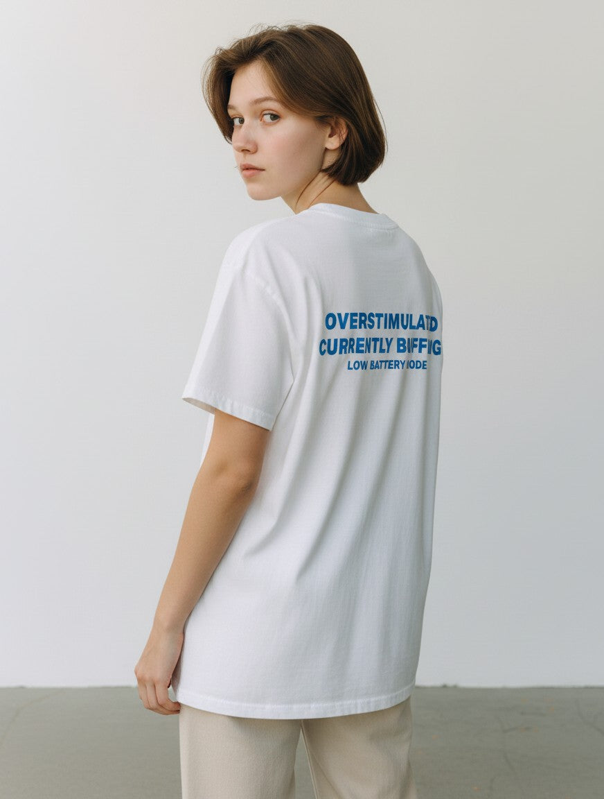 mi-DONE oversized white cotton t-shirt with blue graphic text on the back, worn by a model in a studio setting.