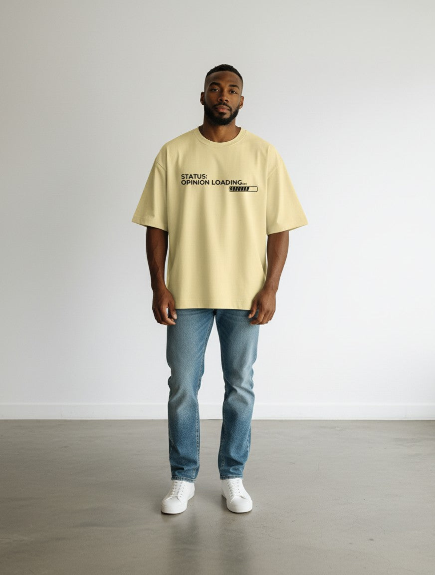 mi-DONE oversized yellow cotton t-shirt with Opinion Loading graphic print worn by a man with blue jeans