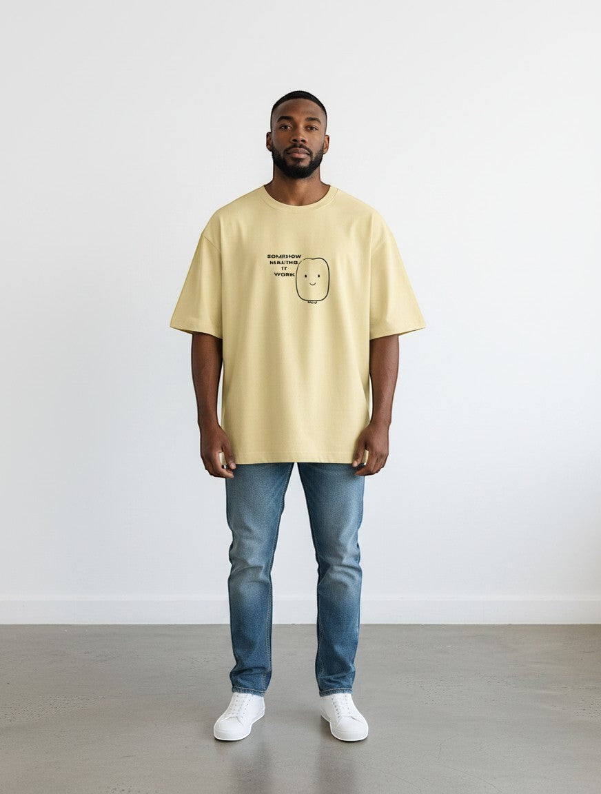 mi-DONE oversized yellow cotton t-shirt with a graphic print, worn by a man with blue jeans and white sneakers.
