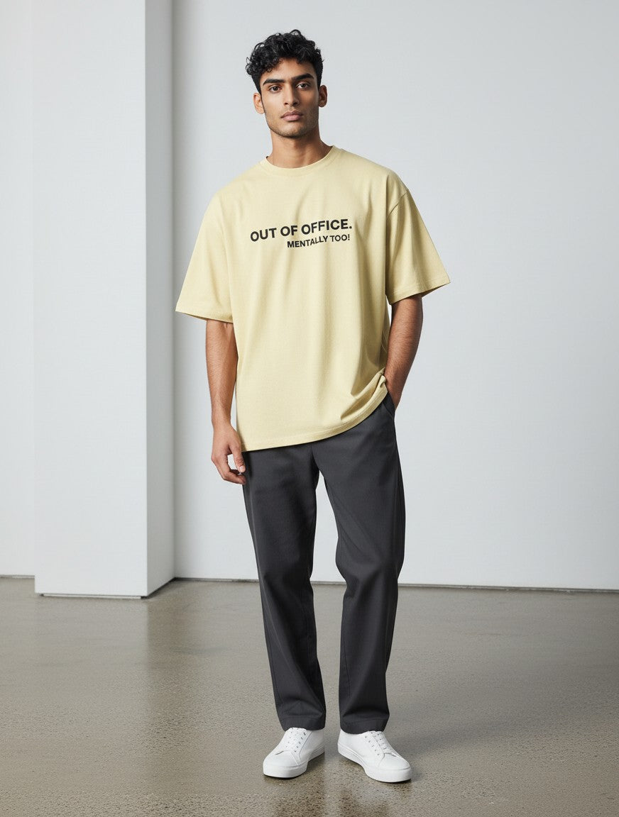 mi-DONE oversized yellow cotton t-shirt with Out of Office graphic print worn by a man with dark trousers