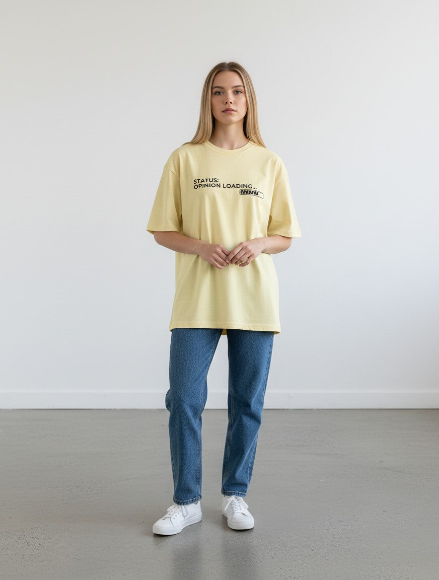 mi-DONE oversized pale yellow cotton t-shirt with Opinion Loading graphic print worn by a woman with blue jeans