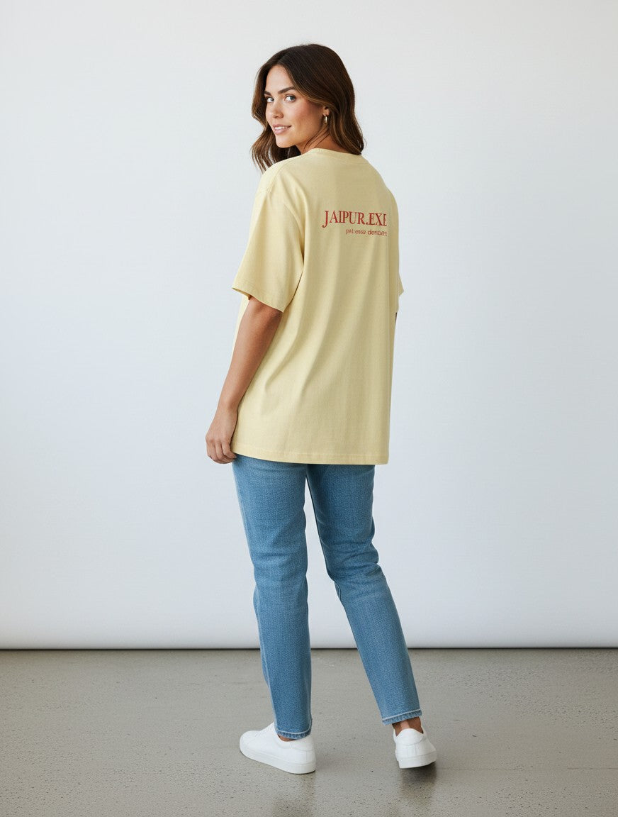 mi-DONE oversized yellow cotton t-shirt with Jaipur graphic print on back worn by a woman with blue jeans