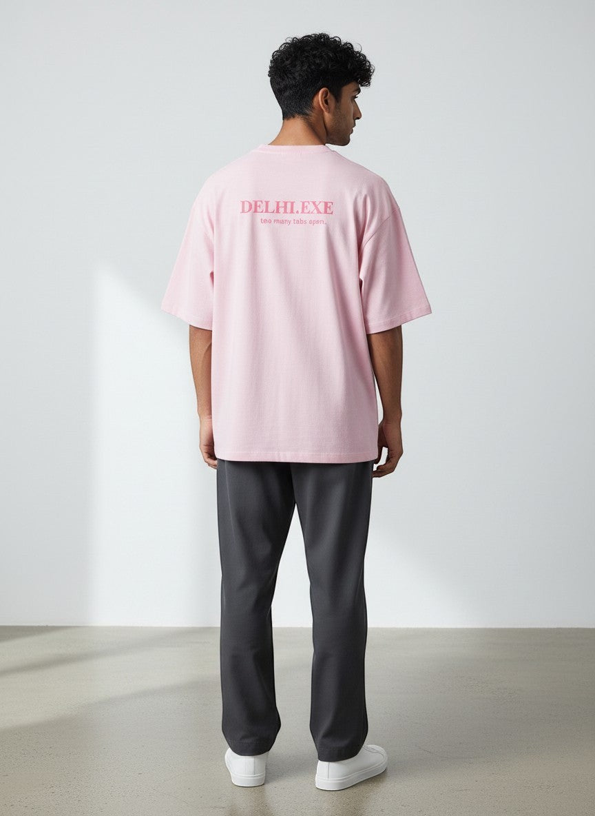 mi-DONE oversized pink cotton t-shirt with Delhi.exe graphic print on back, worn by a man with dark trousers