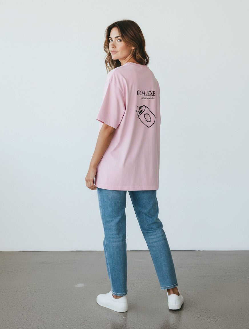 Woman wearing a pink mi-DONE oversized cotton t-shirt with a Goa graphic print on the back, paired with blue jeans.