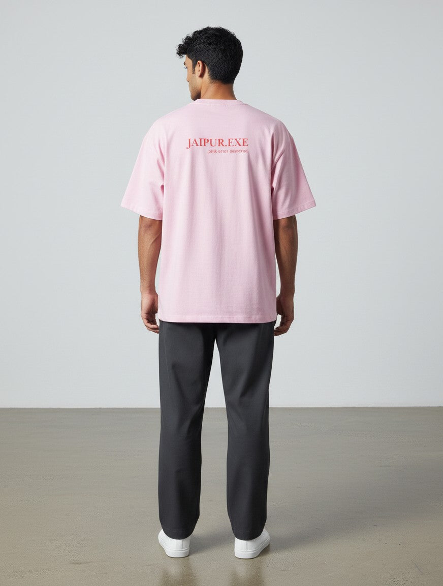 mi-DONE pink oversized cotton t-shirt with drop shoulders and Jaipur.exe graphic print on the back, worn by a man.